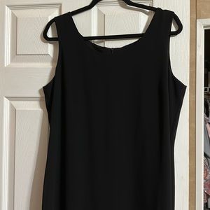 Black sleeveless dress. Sheer material with built in slip. Split in the back.